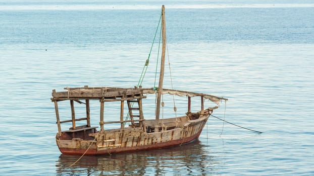 An old wooden boat anchored near the shores of Zanzibar in Tanzania