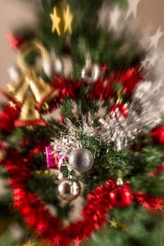 Christmas tree decoration with, lights, garland, tinsel and christmas ball