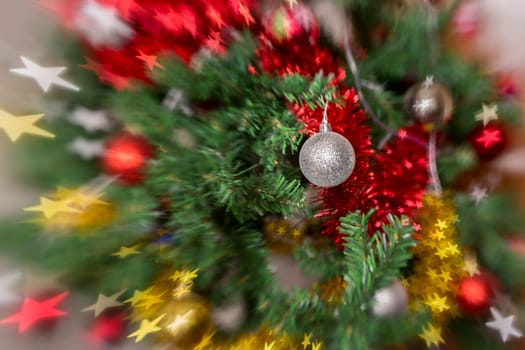 Christmas tree decoration with, lights, garland, tinsel and christmas ball