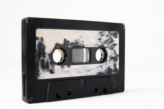 Ancient Vintage Used Musicassette over a White Background