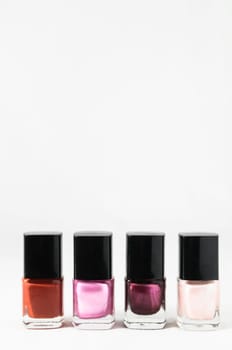 Colorful nail polish brush over white background