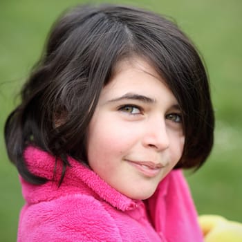 Portrait of a caucasian girl, she is smiling.