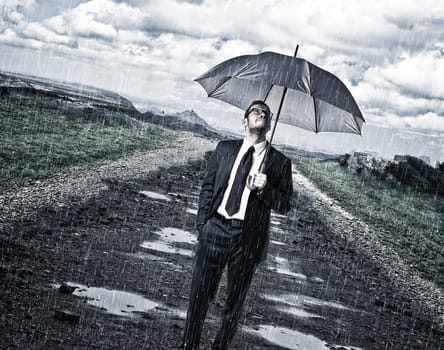 rainy day and man with umbrella on road