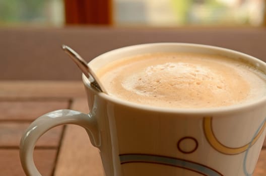 Cup of coffee in front of a window