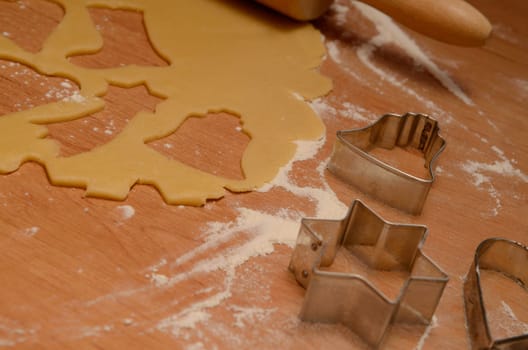 Christmas bakery background with baking tin, cut out some cookies