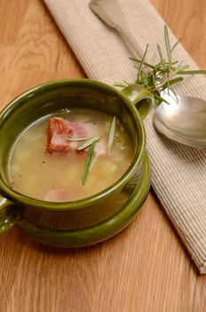 Green bowl with bean soup and bacon