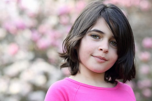 Portrait of a caucasian girl, she is smiling.