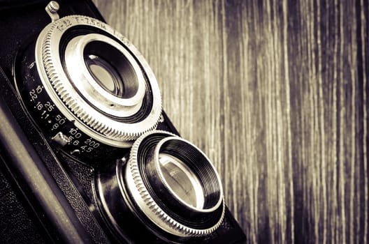 Detail of old fashioned classic camera in vintage style