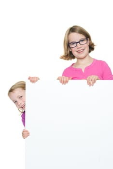 Studio recording of two happy girls with a white billboard against a white background