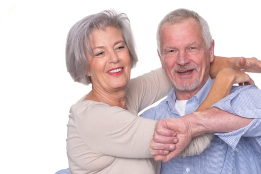 Happy senior couple against a white background
