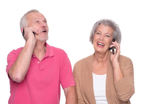 Senior couple with smartphone against a white background