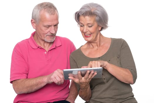 Senior couple with tablet against a white background