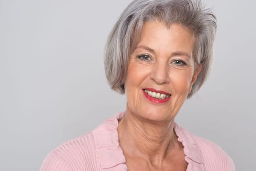 Portrait of the elderly against a grey background