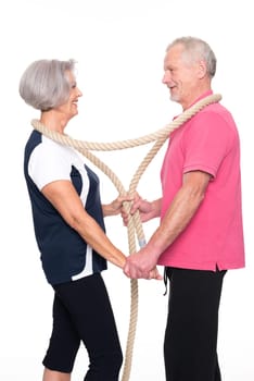 Sporty senior couple against a white background