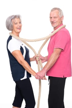 Sporty senior couple against a white background