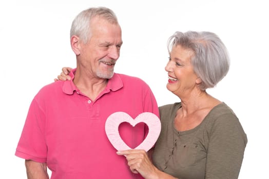 Seniors with a heart against a white background