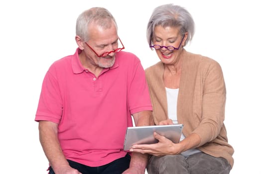 Senior couple with tablet against a white background