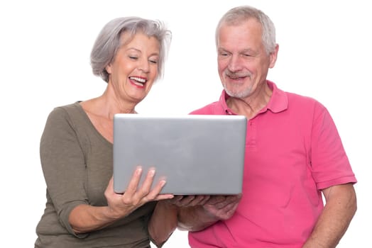Senior couple with computer against a white background