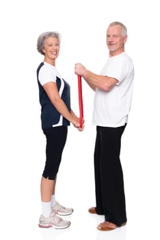 Sporty senior couple against a white background