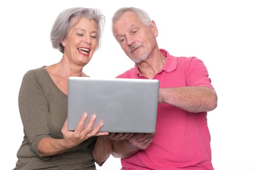 Senior couple with computer against a white background