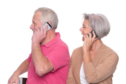 Senior couple with smartphone against a white background