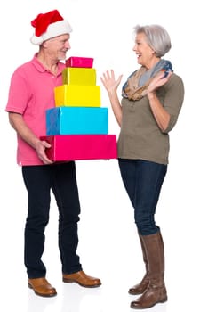 Active seniors with gifts against a white background