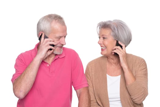 Senior couple with smartphone against a white background