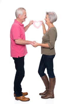Seniors with a heart against a white background