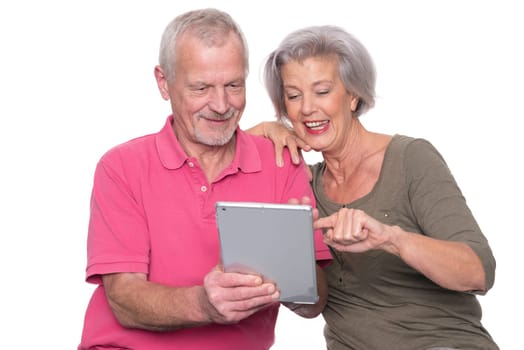 Senior couple with tablet against a white background