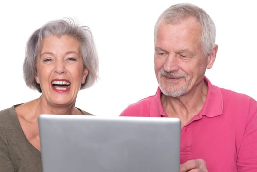Senior couple with computer against a white background