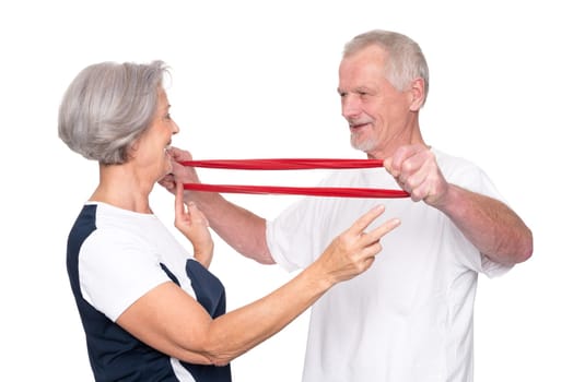 Sporty senior couple against a white background