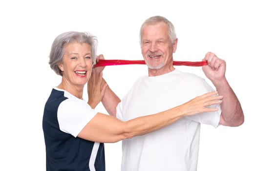 Sporty senior couple against a white background