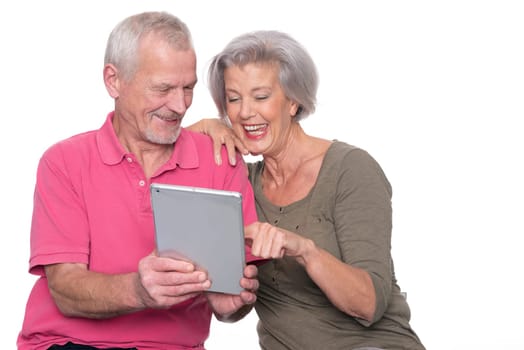 Senior couple with tablet against a white background