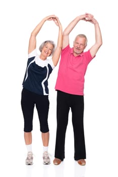 Sporty senior couple against a white background