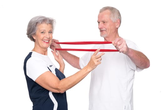Sporty senior couple against a white background