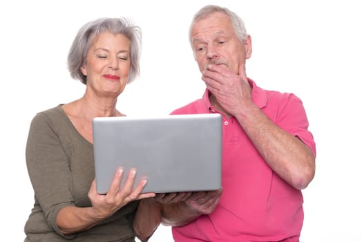 Senior couple with computer against a white background