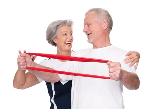 Sporty senior couple against a white background