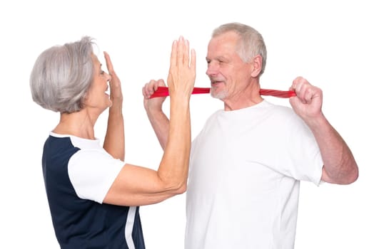 Sporty senior couple against a white background
