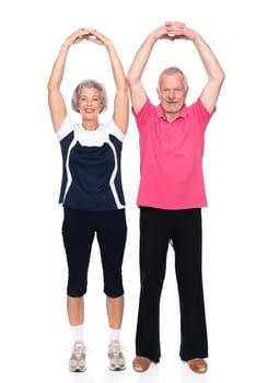 Sporty senior couple against a white background