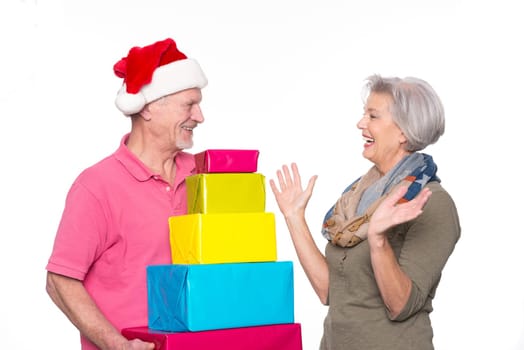Active seniors with gifts against a white background