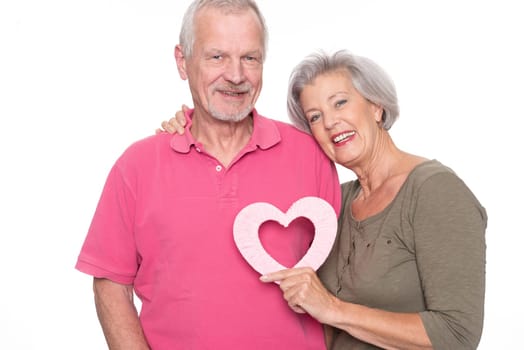 Seniors with a heart against a white background