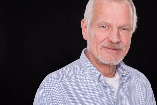 Portrait of a senior against a black background