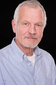 Portrait of a senior against a black background