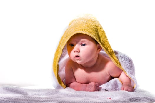 Sweet newborn baby wrapped in a towel and smiling, isolated against a white background.