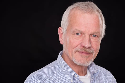 Portrait of a senior against a black background