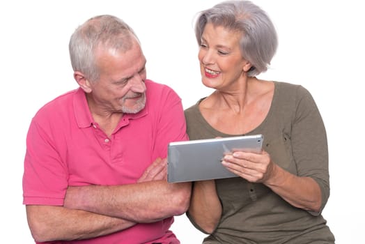 Senior couple with tablet against a white background