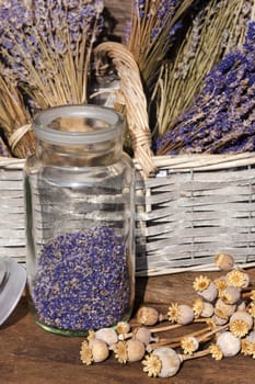 Lavender flowers in glass and tufts in a basket