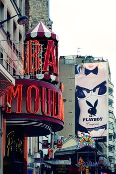 Paris,France -- January 01,2014: The entrance of the Moulin Rouge with red light lettering behind which a poster of Playboy with a nude model was hung on January 1,2014 in Paris.