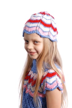 smiling little girl in knitted hat on a white background