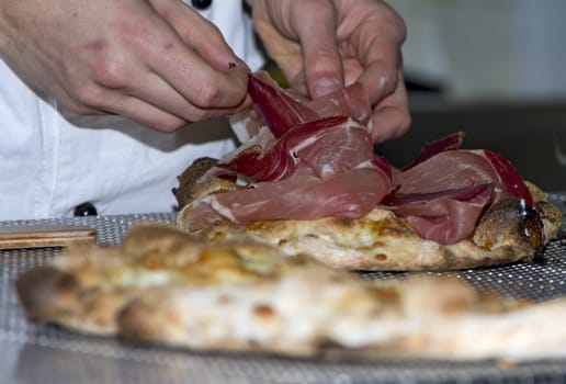 Whites pizzas cooked and stuffed with bacon, artichokes,ham and mozzarella cheese